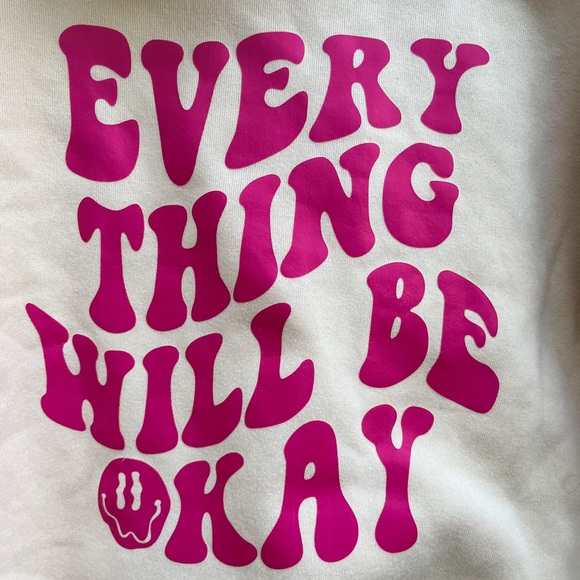 Trendy tan sweatshirt with pink saying of “everything will be okay” on the back - Picture 2 of 3